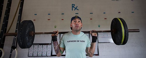 Reymundo Zapata, who had partial knee replacement surgery in April, does squats during a CrossFit workout at Armor Of God Fitness in Gregory